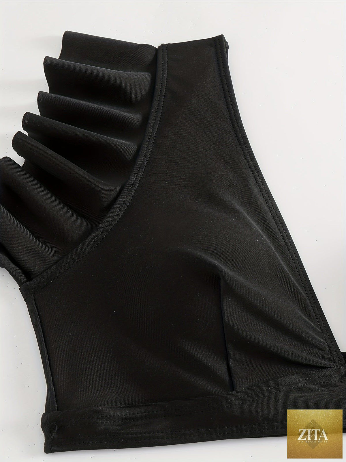 Black solid color bikini set with ruffle V-neck top and high-waisted lettuce trim bottoms, made of stretchy fabric for summer beach days.