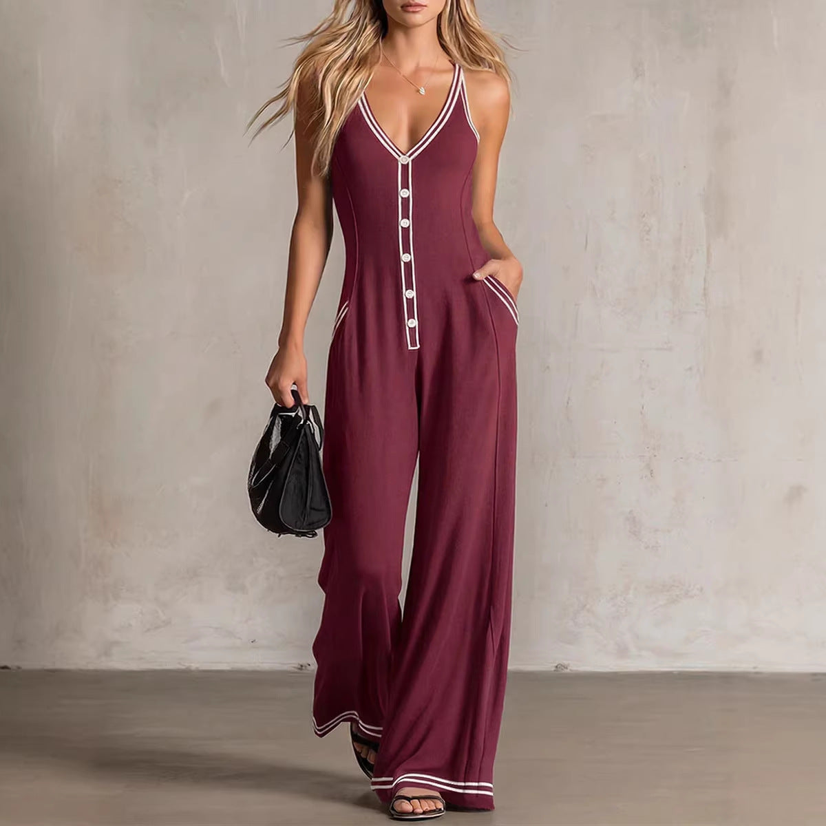 Women's FitiqueFit V-neck backless wide-leg jumpsuit featuring a high waist and casual style, shown on a model.