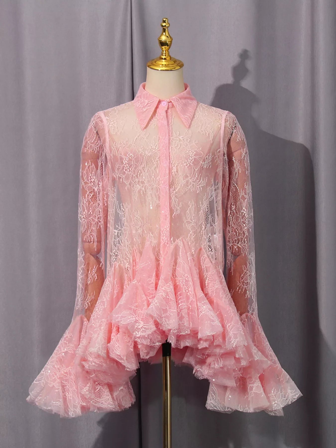 Lace long sleeve dress with ruffled hem, stylish design from Shopiebay, featuring intricate lace details and a flowing silhouette.