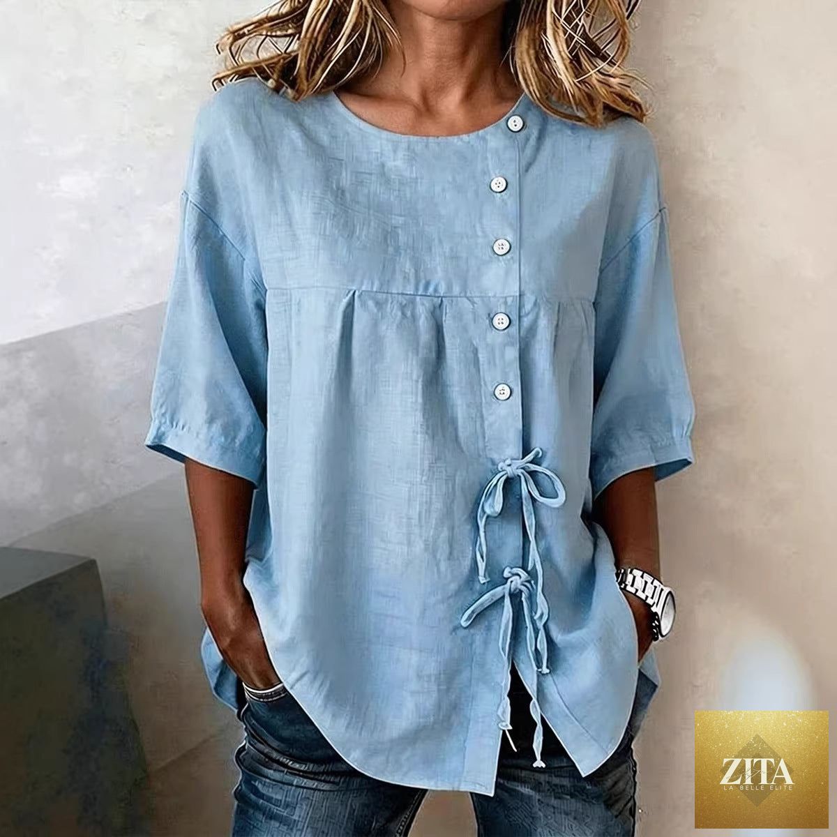 Women's linen lace-up button shirt with 3/4 sleeves and asymmetric design from Zita La Belle Elite, shown in a stylish top view.