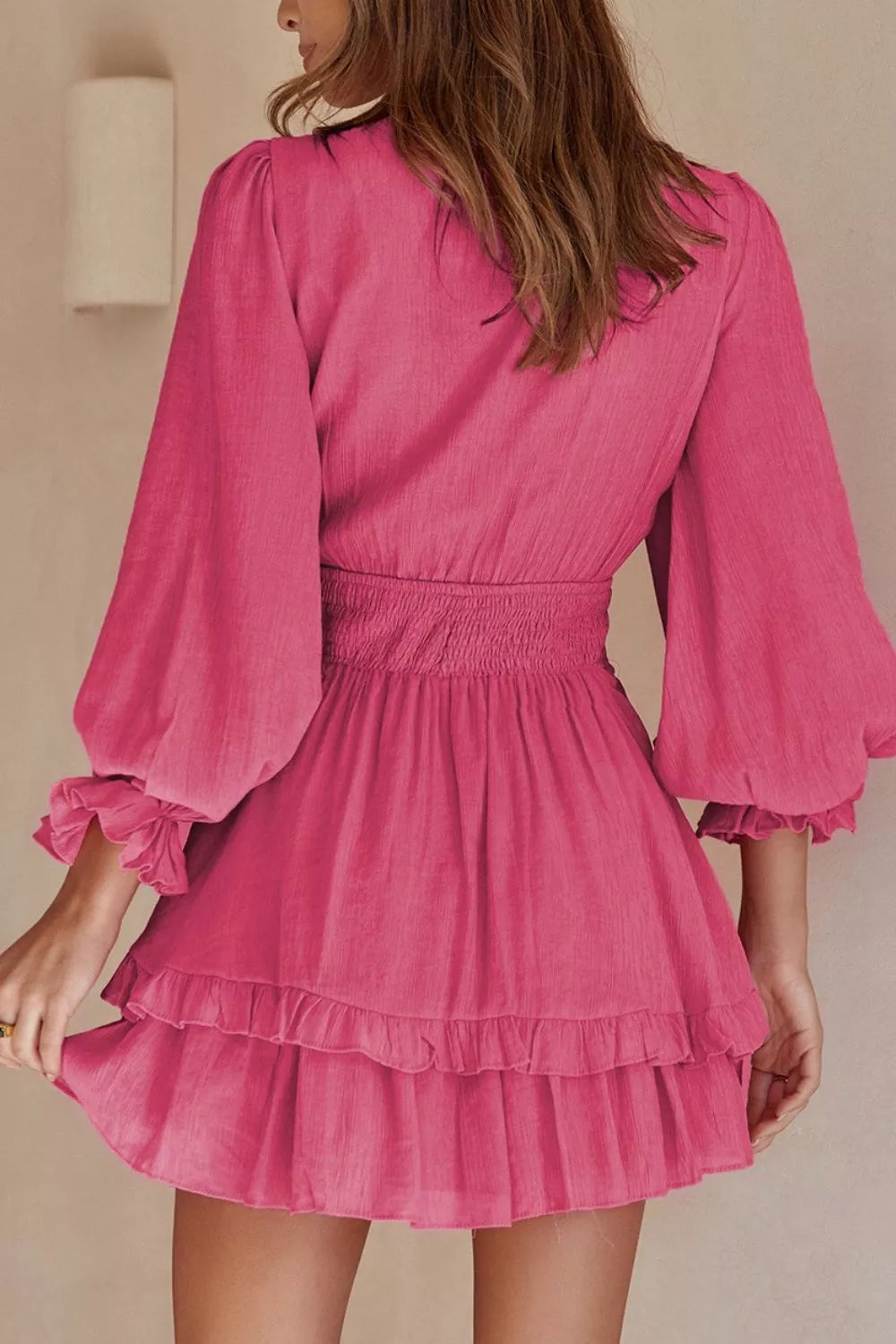 Elegant tie-front ruffle mini dress with smocked waist by Shopiebay, featuring flowing fabric and stylish design.