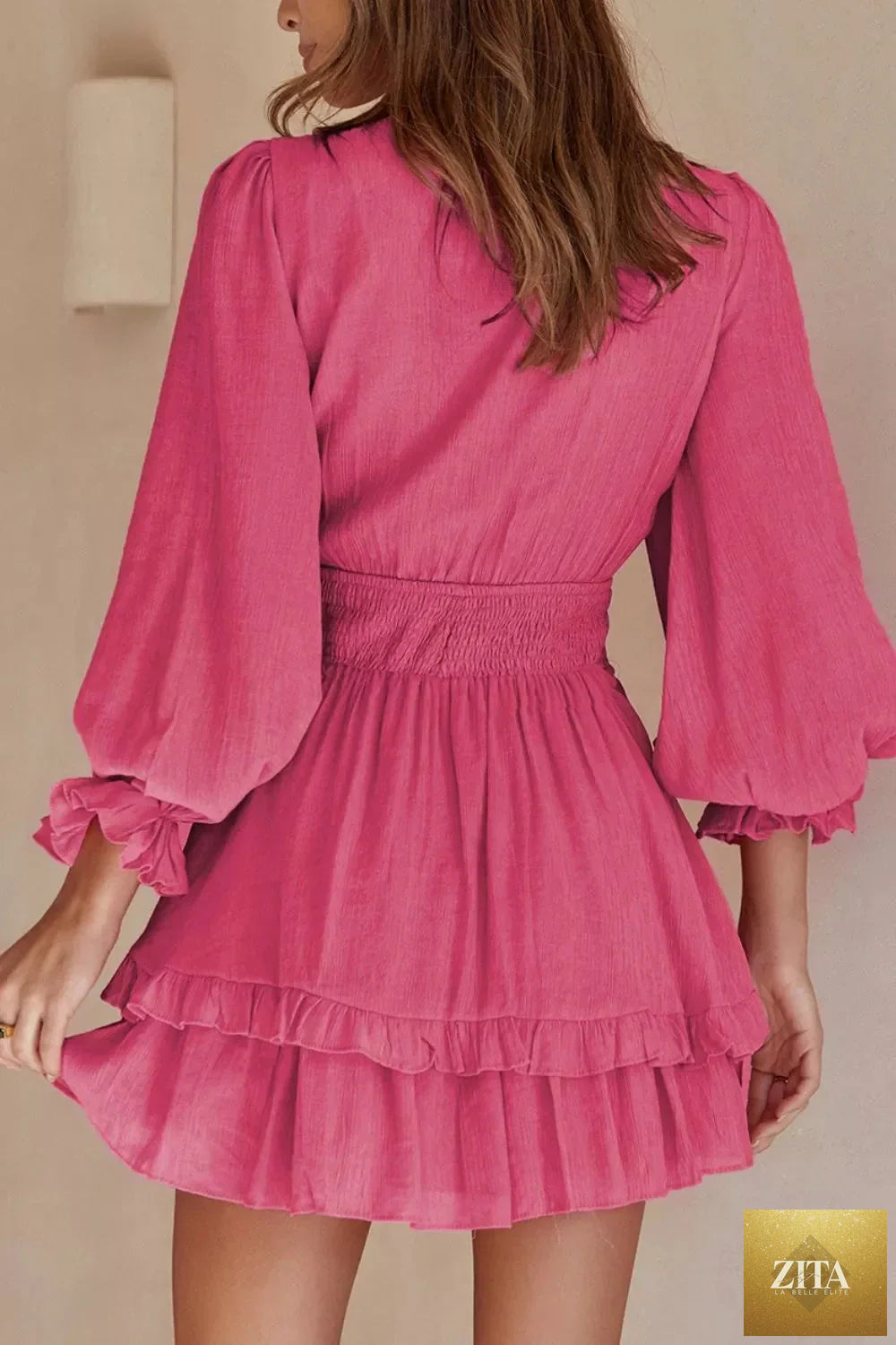 Elegant tie-front ruffle mini dress with smocked waist by Shopiebay, featuring flowing fabric and stylish design.