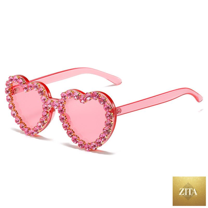 Peach heart-shaped rhinestone sunglasses with Y2K style from FitiqueFit, featuring bold frames and sparkling embellishments.