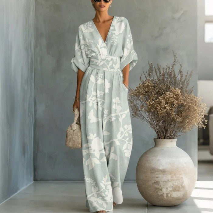 Women's waist-cinched V-neck printed wide-leg jumpsuit by FitiqueFit, featuring a casual, stylish design and comfortable fit.