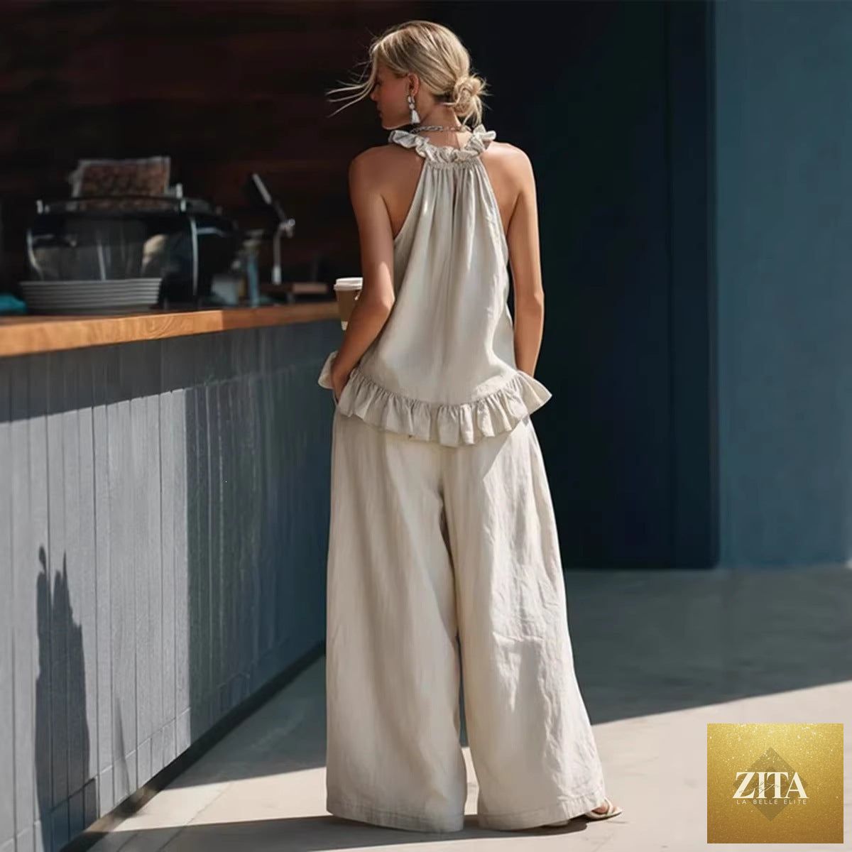 Zita La Belle Elite halterneck loose two-piece casualwear set with pleated fabric and asymmetric pockets on top and pants.
