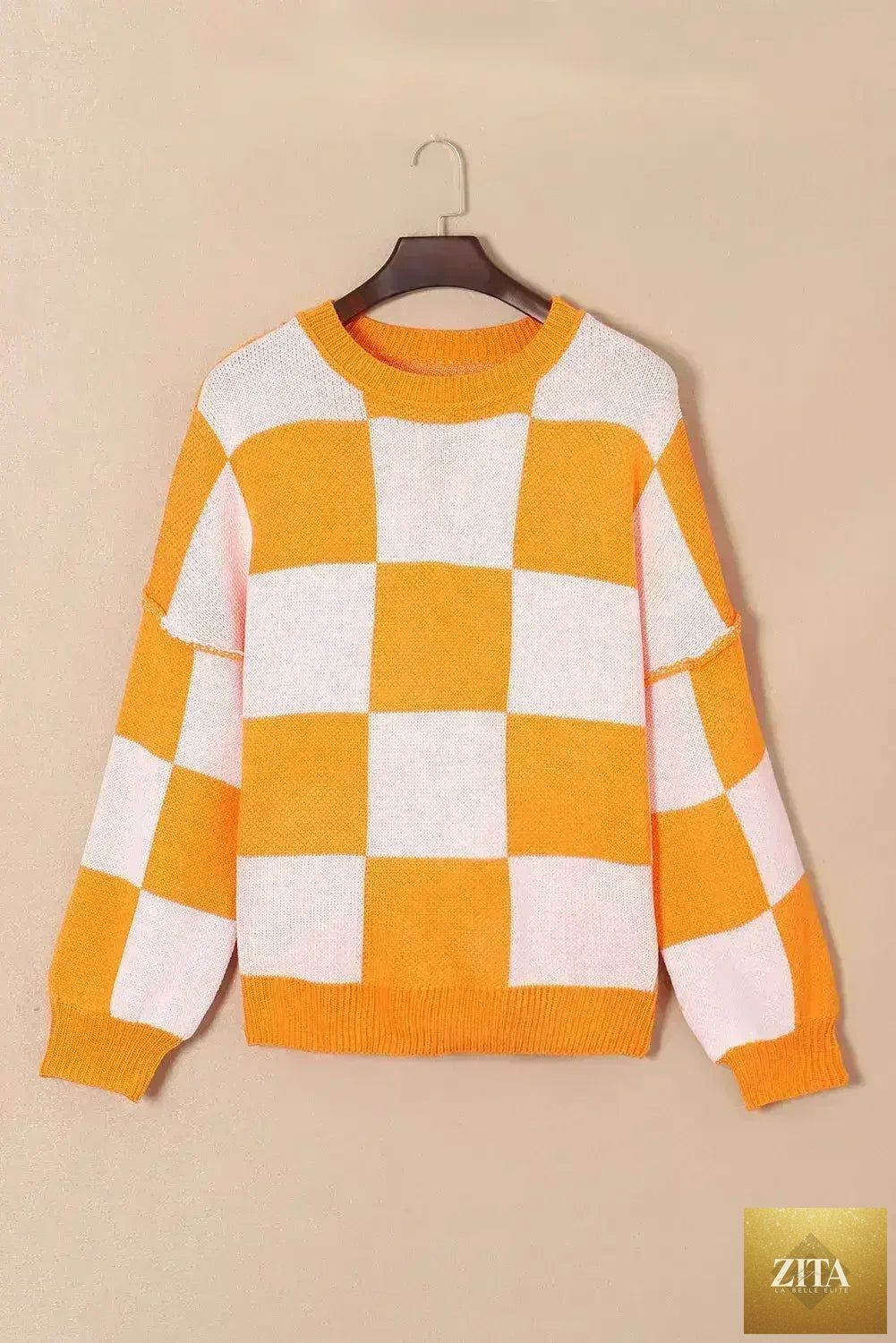 Orange checkered bishop sleeve sweater by Femstylo, featuring a cozy knit fabric and stylish bishop sleeves.