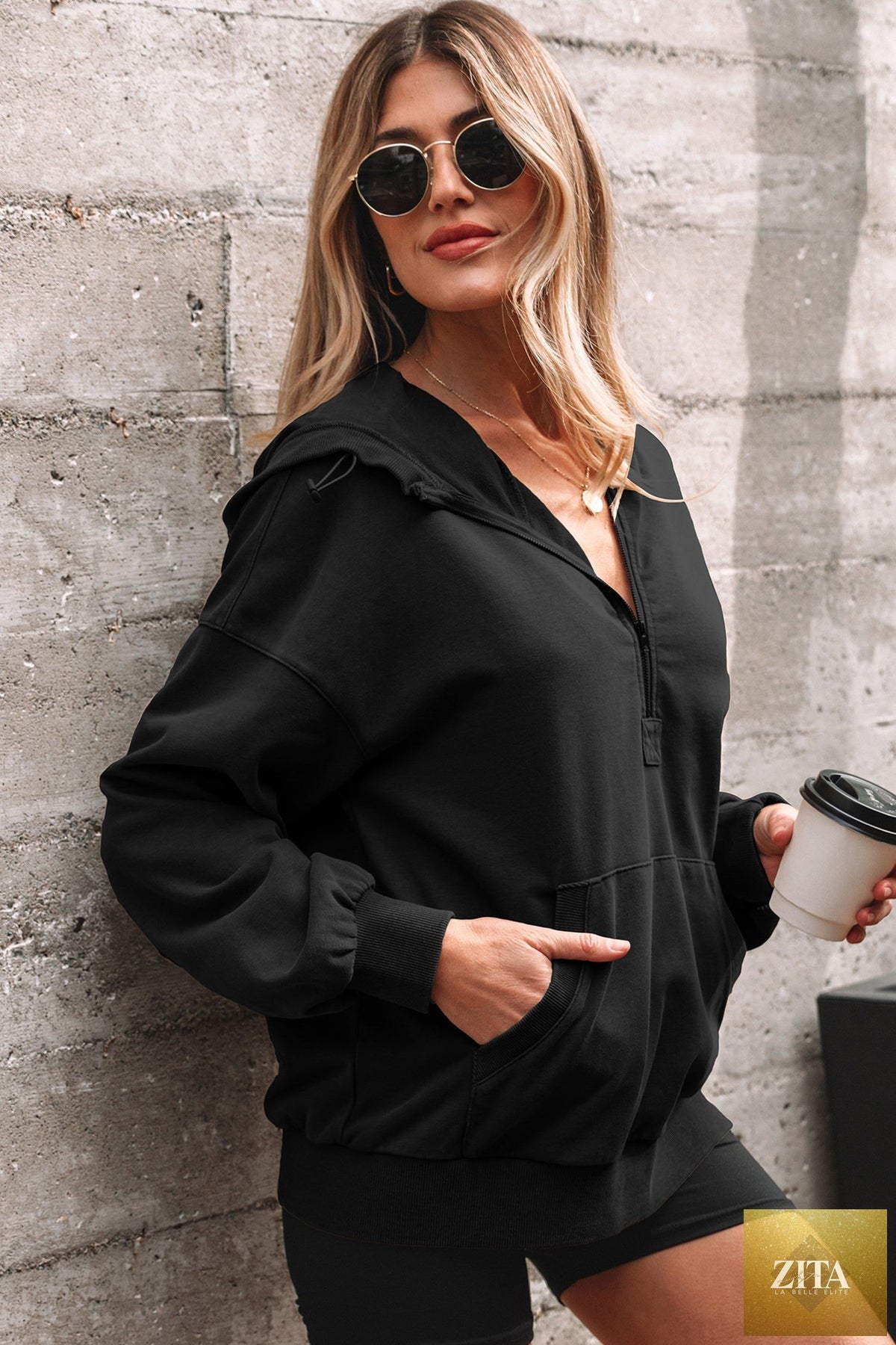 Black half zip hoodie with kangaroo pocket and mineral wash finish, casual baggy sweatshirt by Wild and Free Boutique.