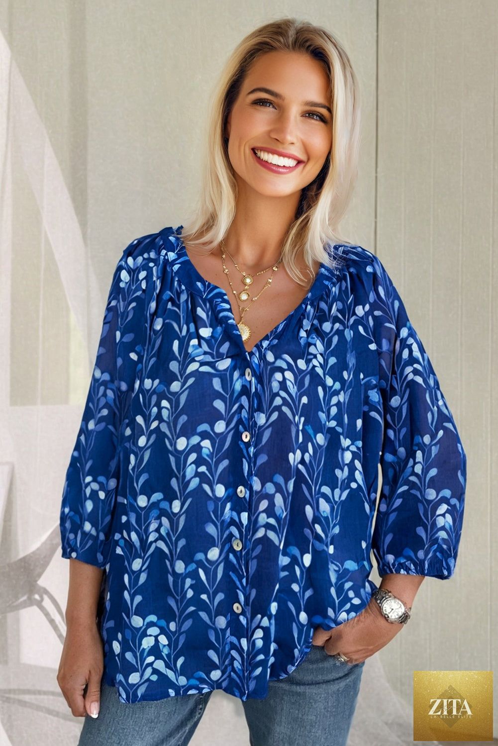 Blue botanical print blouse with bracelet sleeves and notched neckline, stylish top from Wild and Free Boutique.