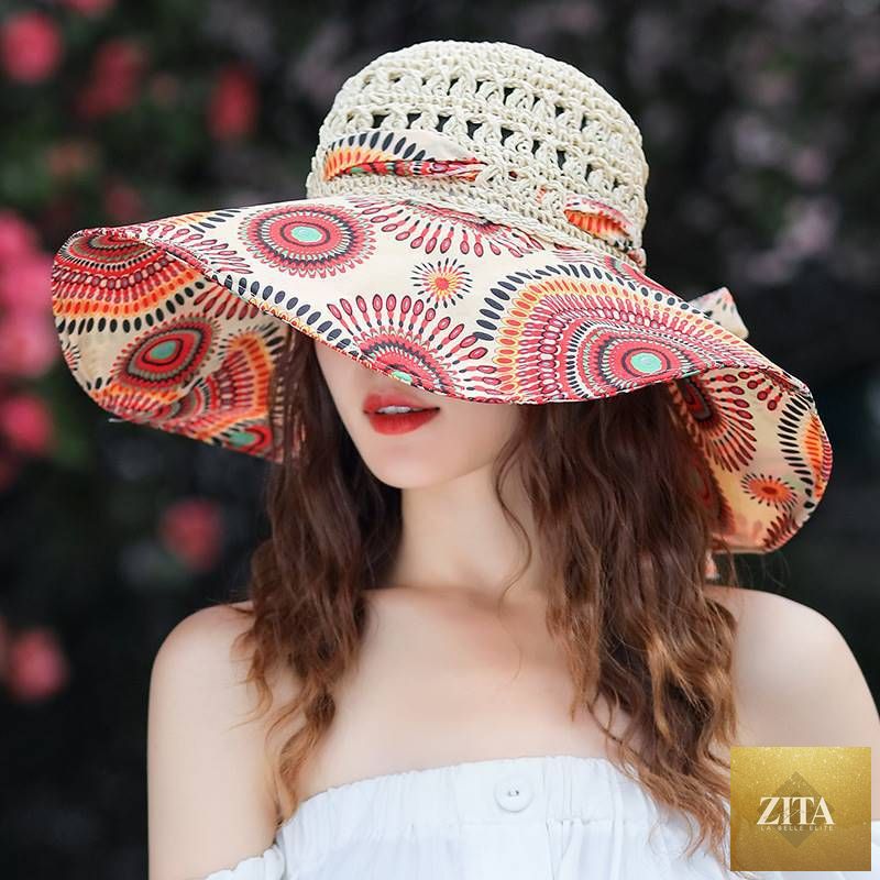 Women's patterned straw beach sun hat with round crown and UV protection, by Zita La Belle Elite, ideal for summer outdoor wear.