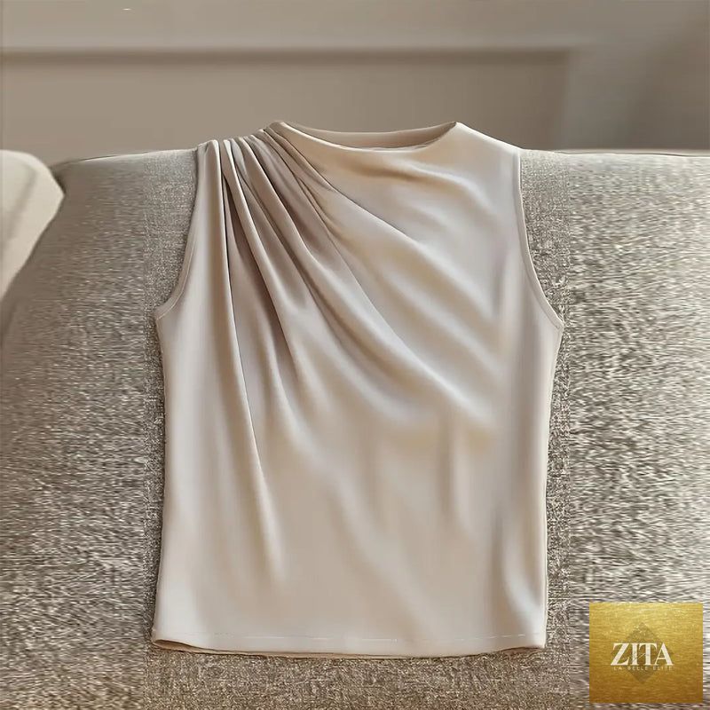 Women's sleeveless mock neck top by FitiqueFit, elegant casualwear in a neutral color, displayed on a hanger.