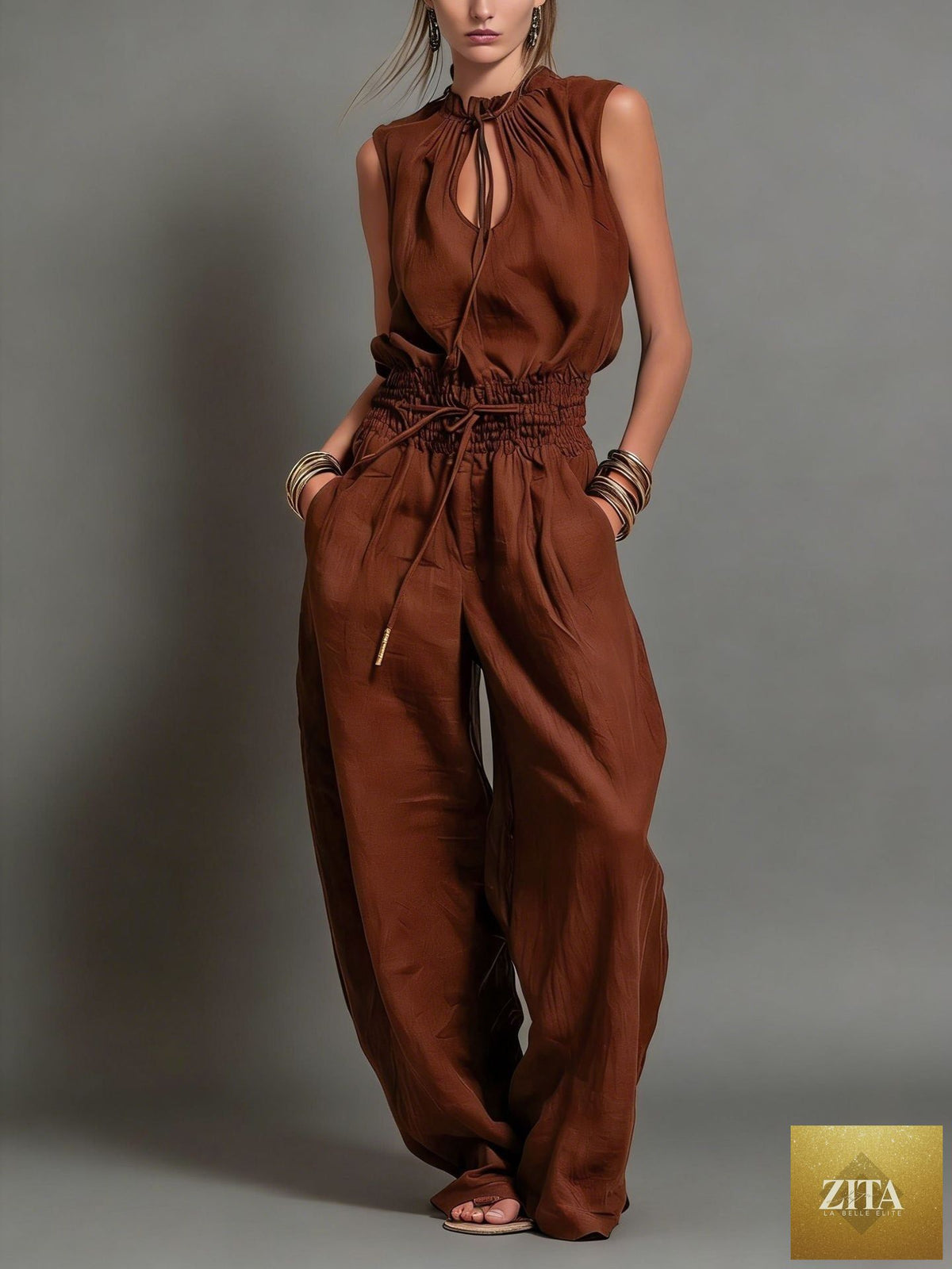 Women's sleeveless high-waist wide-leg pleated jumpsuit by FitiqueFit, featuring a casual, stylish design and flowing fabric.