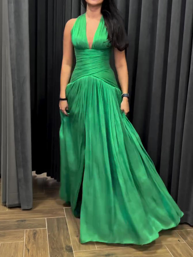 Emerald green plunging neckline gown by The Fashion Celestial with pleated skirt and side slit, perfect for formal occasions.