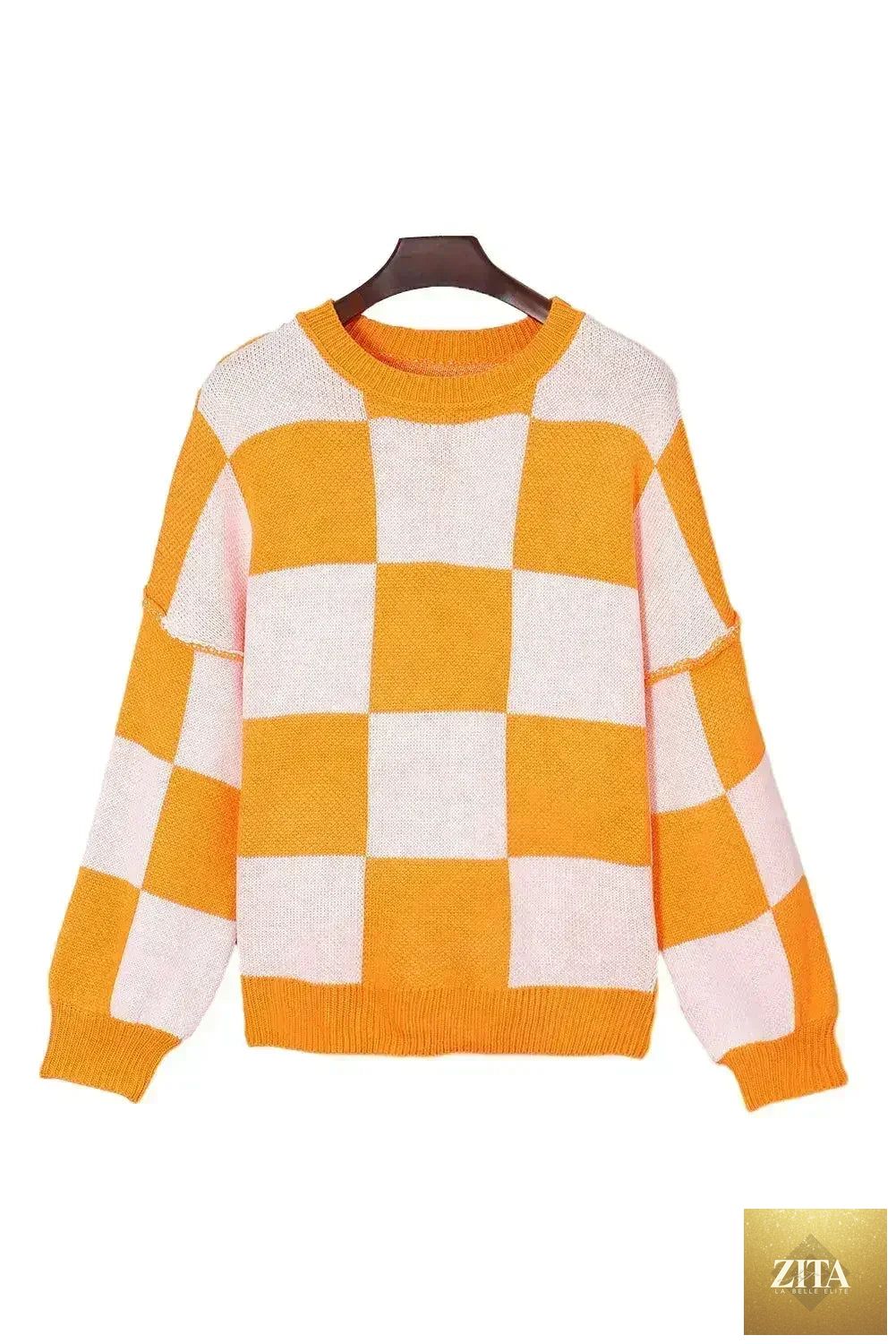 Orange checkered Femstylo sweater with bishop sleeves, cozy knit design, perfect for stylish casual wear.