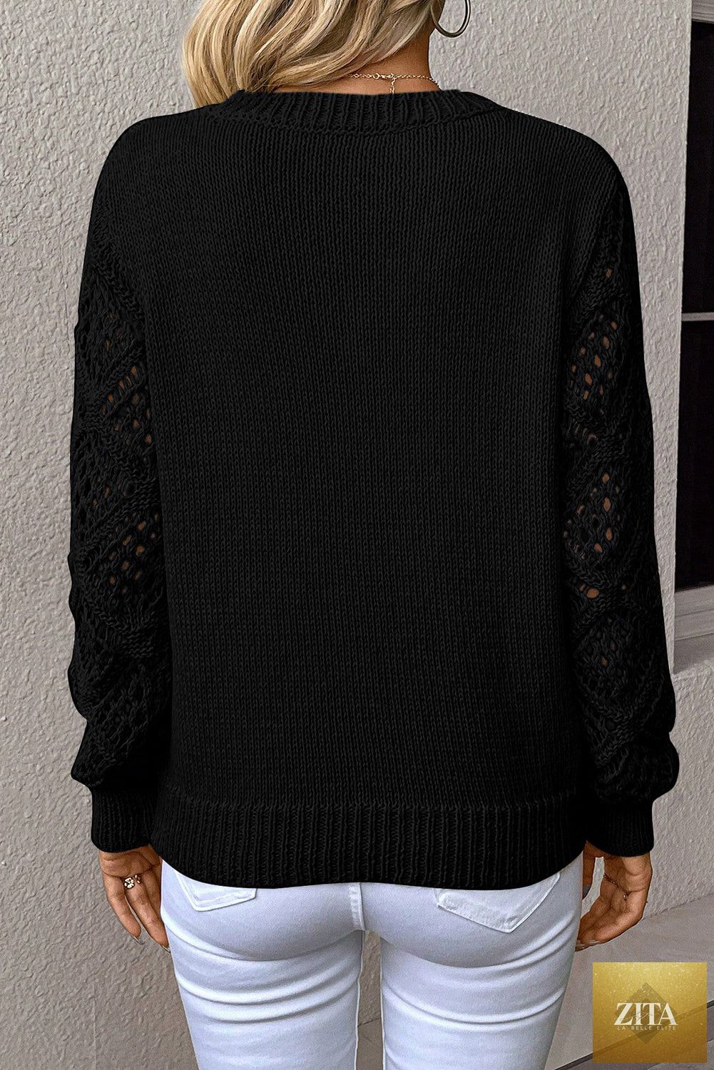 Black solid V-neck pointelle knit sweater with patchwork sleeves from Wild and Free Boutique, showcasing a cozy, stylish design.