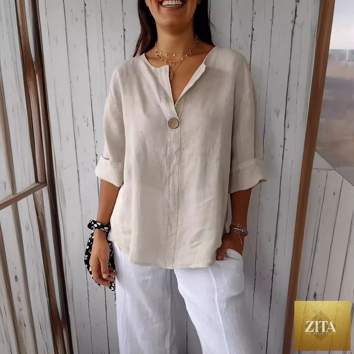 Women's V-neck long-sleeve button-up blouse by Zita La Belle Elite, loose fit casual top with V-neck and button details.