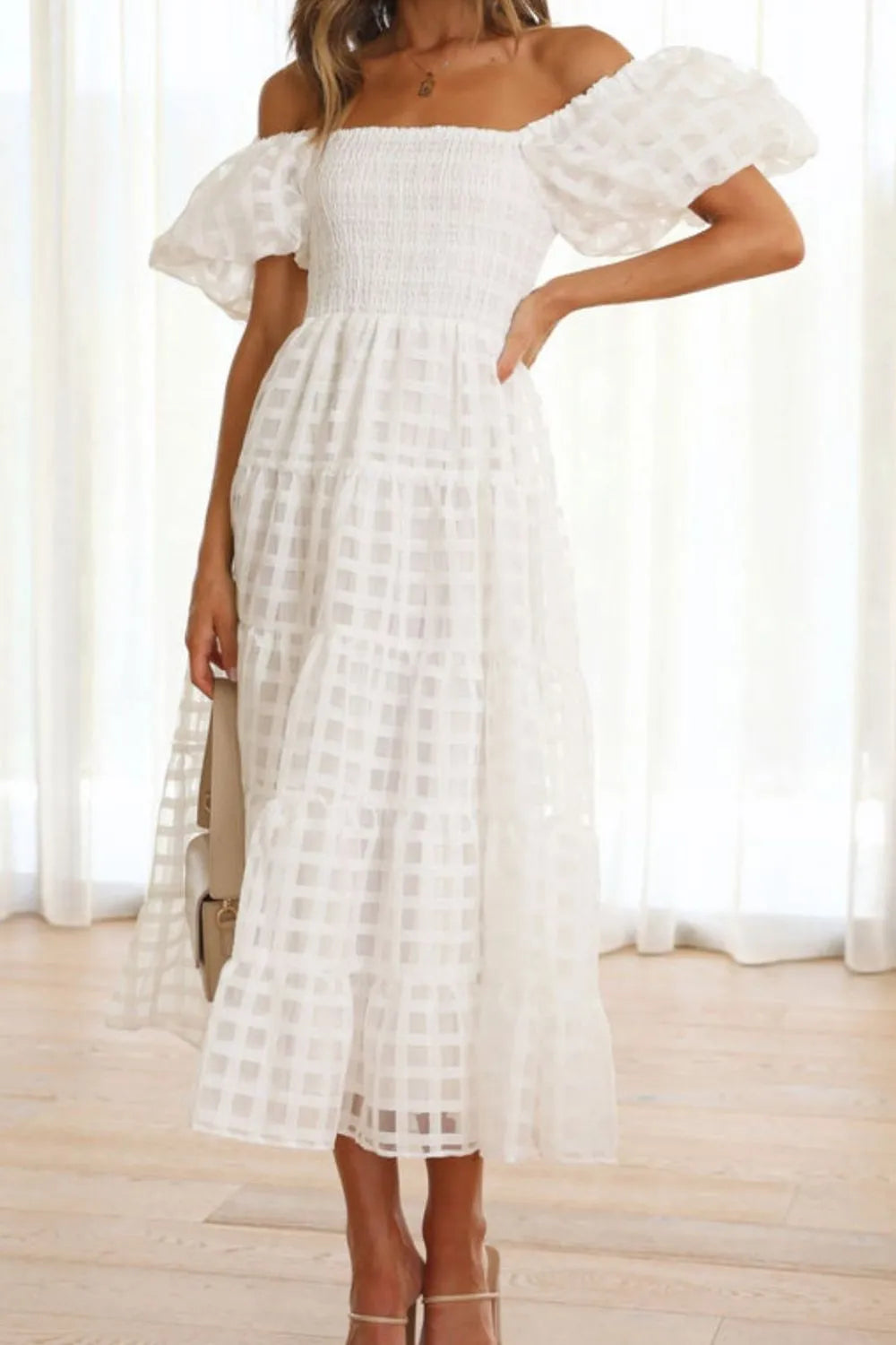 Off shoulder short puff sleeve midi dress by Shopiebay, featuring a fitted bodice and flowing skirt in a stylish design.