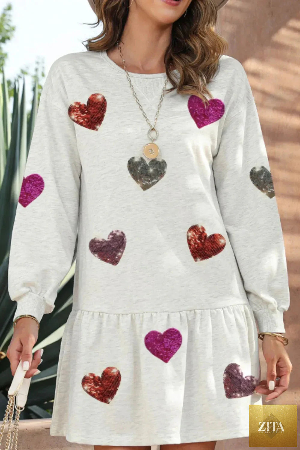 Sequin heart design round neck long sleeve mini dress by Shopiebay, featuring a sparkling sequin pattern and fitted silhouette.