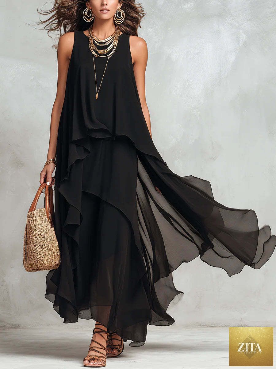 Black asymmetrical ruffle mesh chiffon sleeveless maxi dress by FitiqueFit, showcasing flowing fabric and elegant design in a casualwear style.