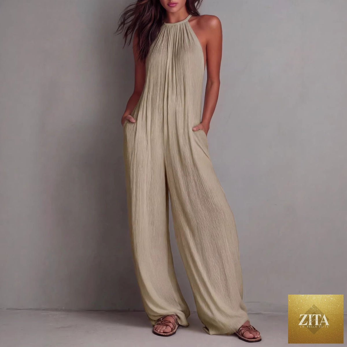 Women's sleeveless open-back wide-leg pleated jumpsuit by Zita La Belle Elite, showcasing the casualwear style with flowing fabric and elegant design.