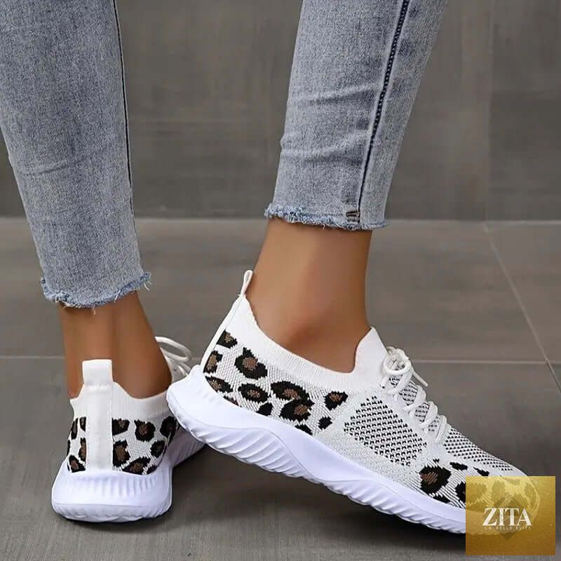 White women's sneakers with leopard print, lace-up design, from SnagBag, ideal for sports and casual wear.
