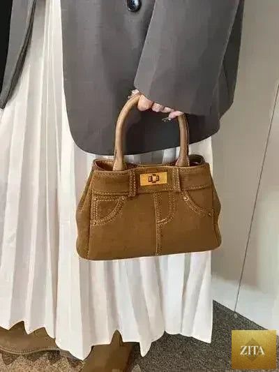 Femstylo stylish suede handbag with adjustable strap and dual-use design, featuring a chic and versatile accessory for everyday use.