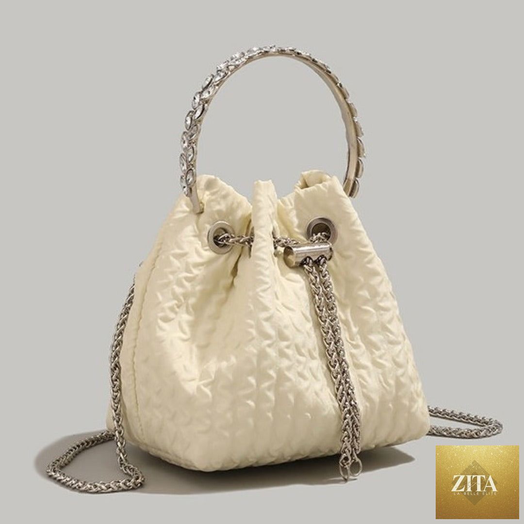 Women’s nude luxury rhinestone chain evening handbag with drawstring bucket design, perfect for parties and special occasions.