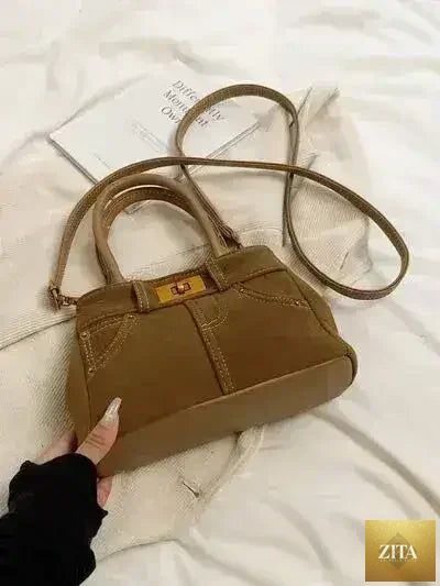 Femstylo stylish suede handbag with adjustable strap and dual-use design, showcasing a chic, versatile accessory for everyday use.