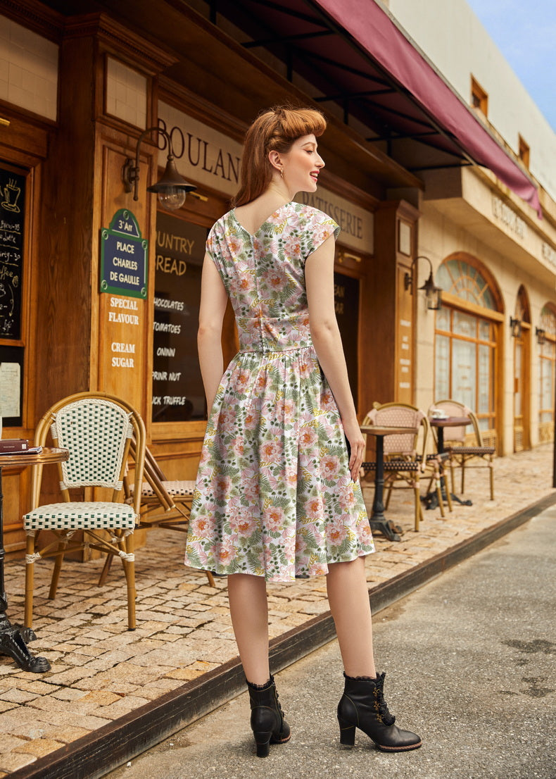 Pink floral Greta dress by Retrolicious, featuring a vintage-inspired design with a fitted bodice and flowing skirt.