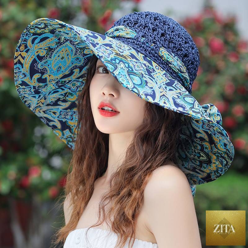 Women's patterned straw beach sun hat with round crown and wide brim, provides UV protection for summer outdoor activities.