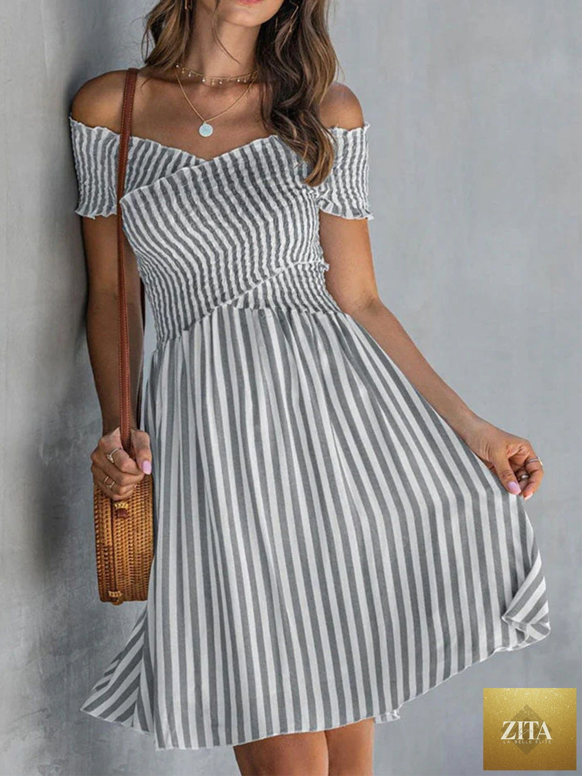 Women's off-shoulder striped waist-cinching midi dress by Zita La Belle Elite, casualwear, with a fitted silhouette and bold stripe pattern.