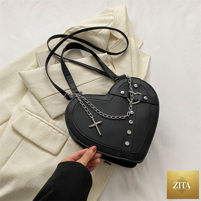 Korean-style cute heart-shaped shoulder crossbody bag with niche design, featuring social buzz eSIMs branding, in a vibrant color.