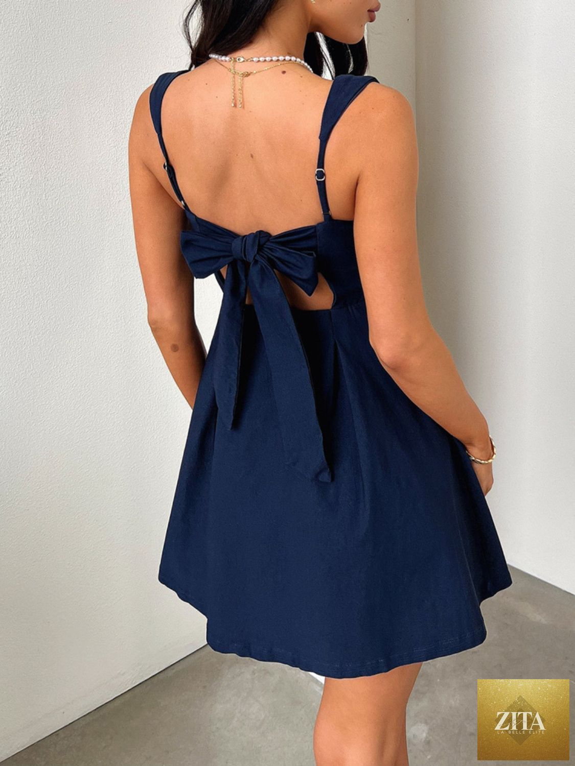 Dark blue Stevvex mini dress with square neck and bow back, feminine and flattering for girls, stylish and elegant for special occasions.