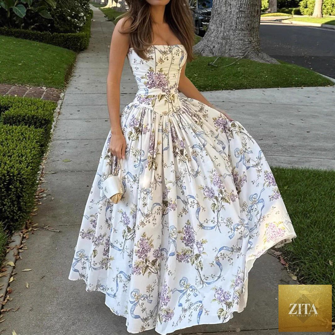 Printed strapless backless maxi dress by FitiqueFit, showcasing a fitted long dress design with a flowing silhouette.