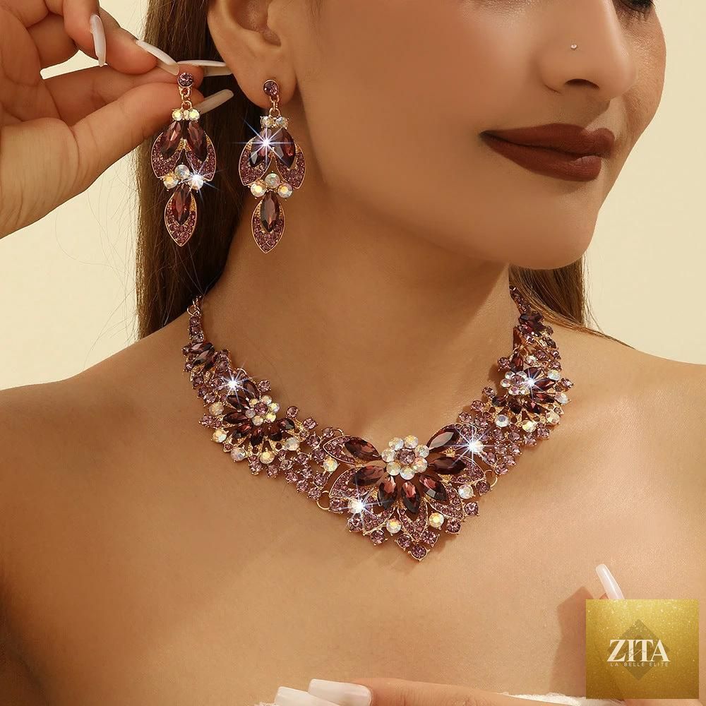 MANDOTOS crystal earrings suite featuring high-profile, elegant earrings with sparkling crystals on a neutral background.