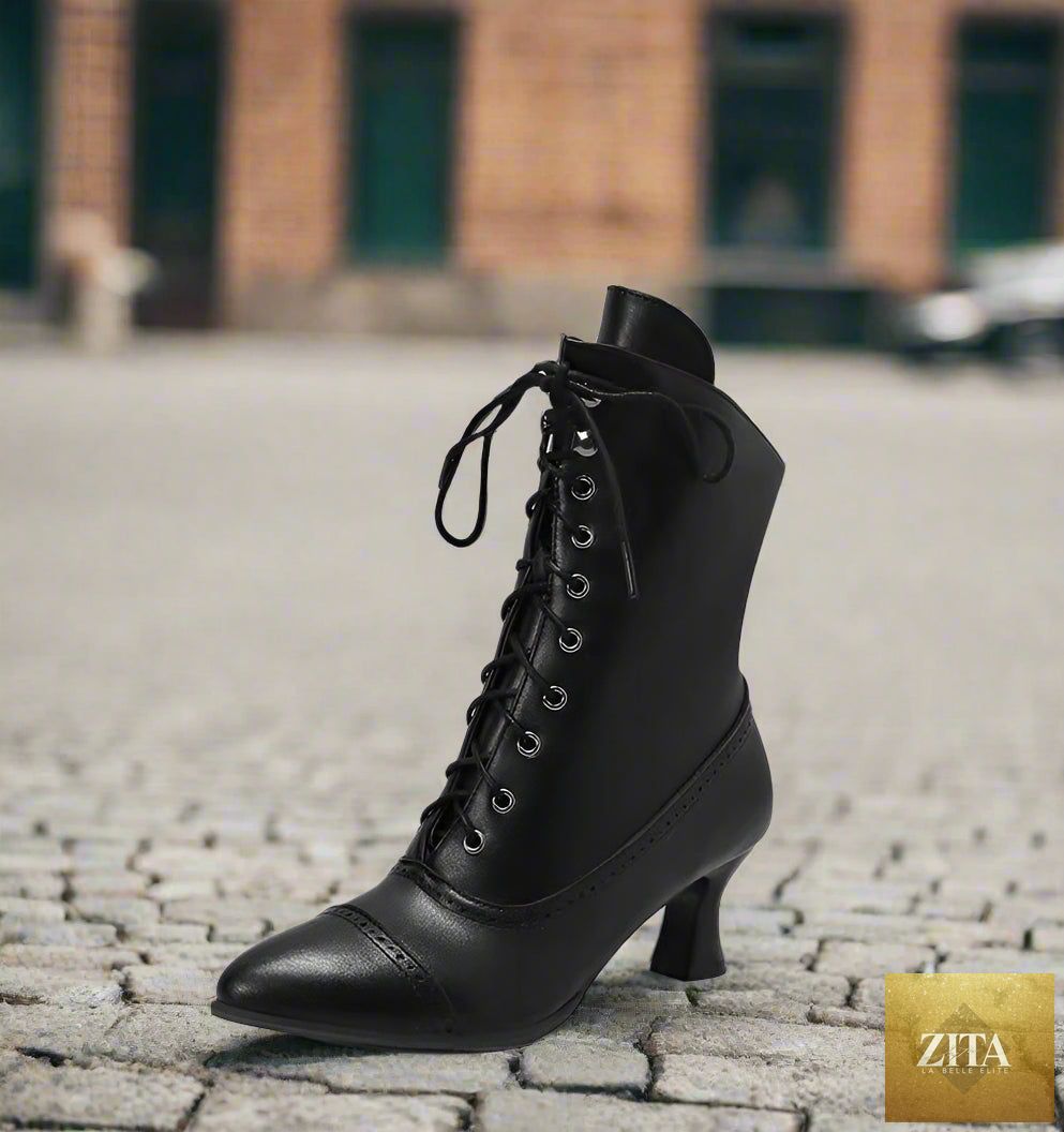 Women’s high heel Martin boots by Zita La Belle Elite featuring British motorcycle fashion style, black leather with buckle accents.