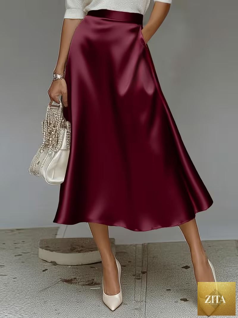 Women's satin solid color mid-length skirt by Zita La Belle Elite with slight stretch, featuring a smooth, elegant fabric and flattering fit.