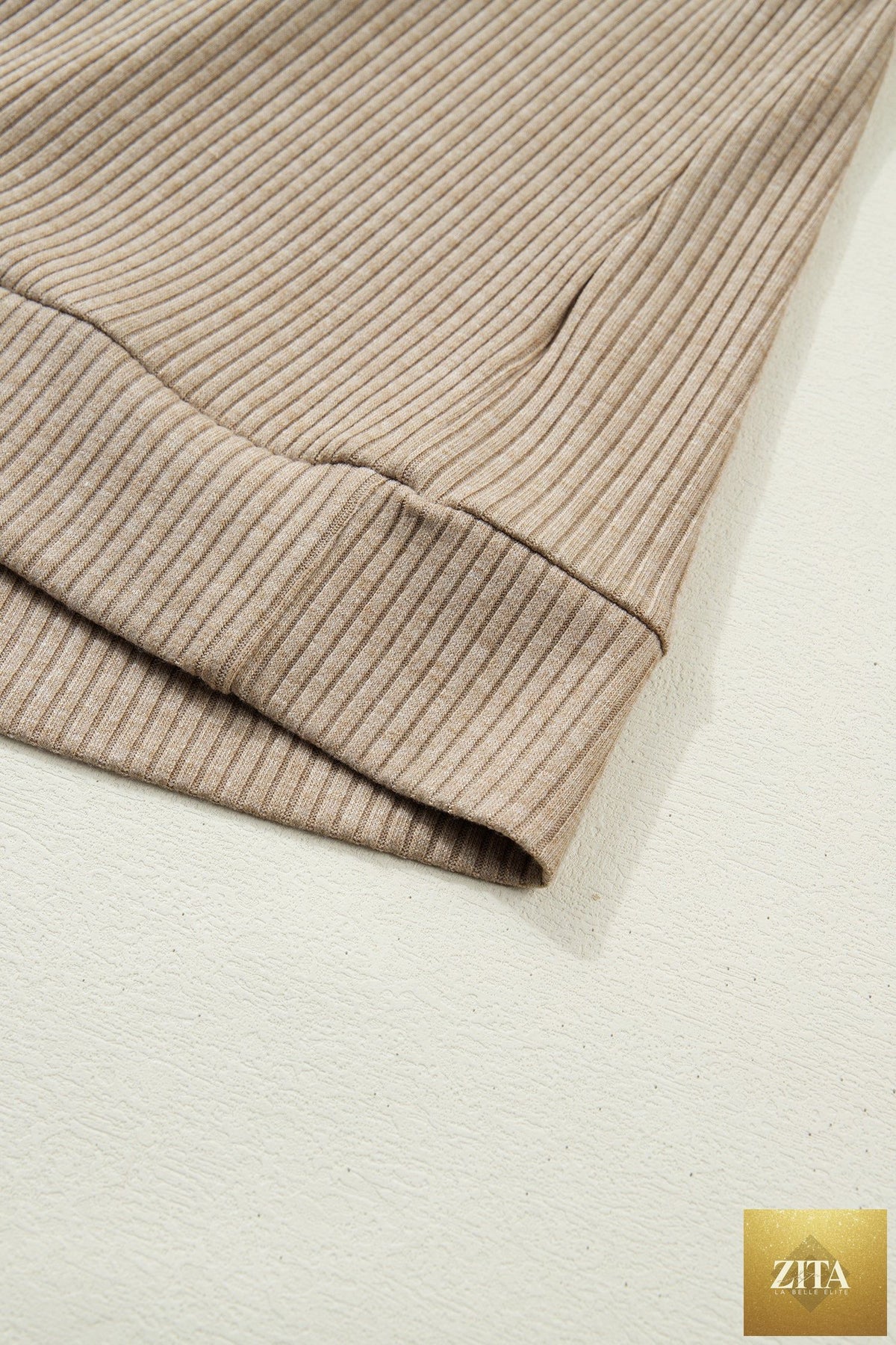 Beige ribbed knit long sleeve top with denim patchwork, button polo collar, and cuffed sleeves from Wild and Free Boutique.