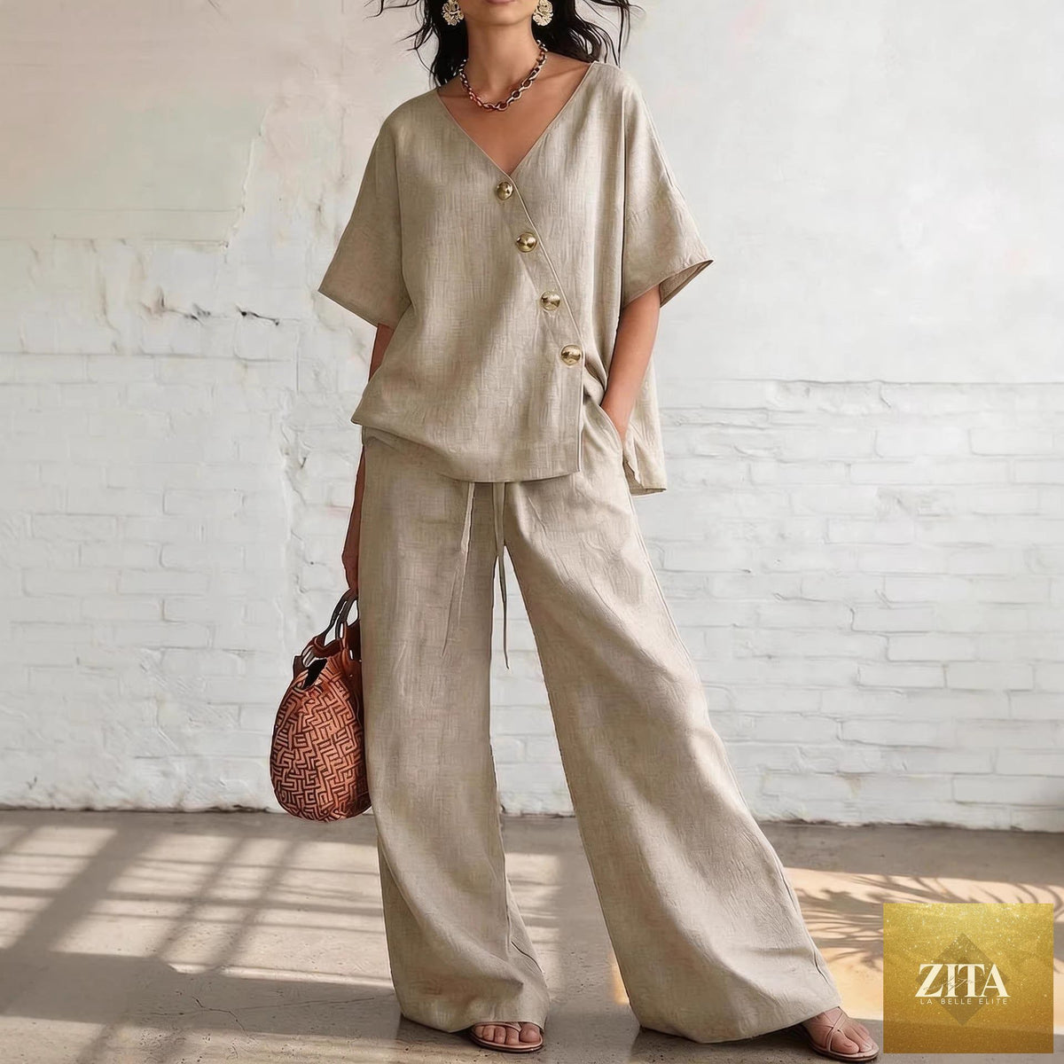 Women's loose cotton-linen V-neck top and wide-leg pants set by Zita La Belle Elite, casualwear, in neutral tones, displayed on a hanger.