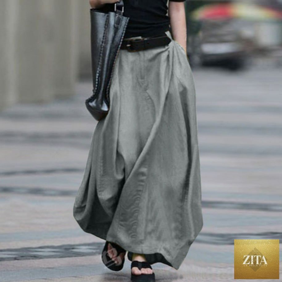 Women's high-waist flared maxi skirt by FitiqueFit in solid cotton linen with side pockets, flowing and stylish for casual wear.