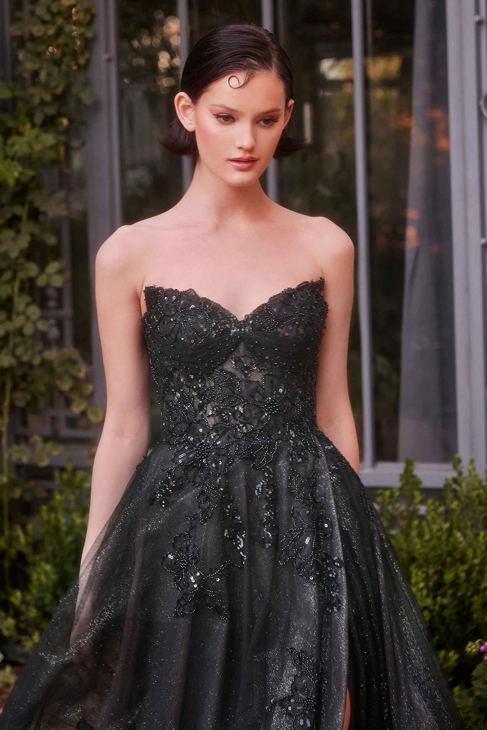 Black and nude strapless layered tulle ball gown by Andrea & Leo, featuring a flowing dress with elegant ruffle details.