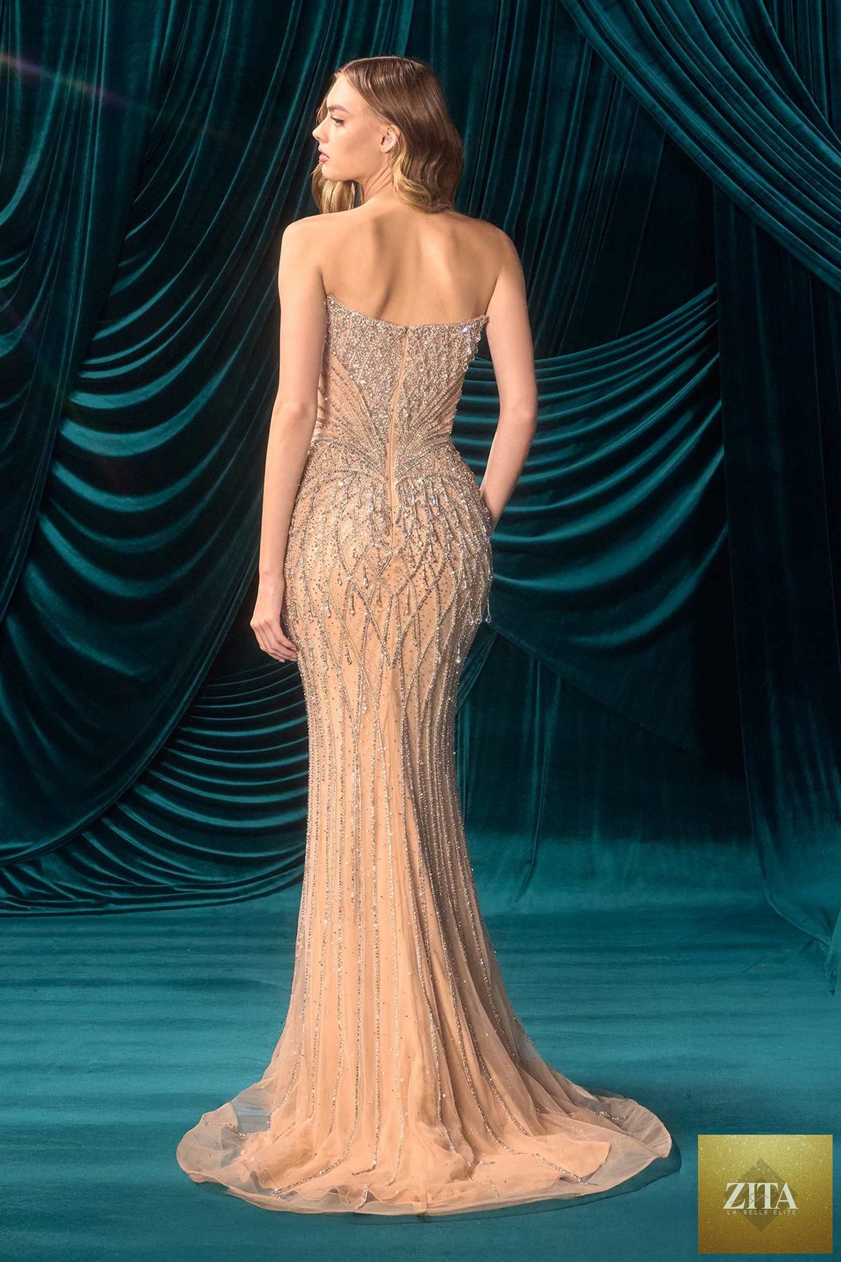 Elegant champagne Andrea & Leo A1503 Pure Glamour fitted evening gown displayed from the back, featuring a sleek silhouette and stylish design.