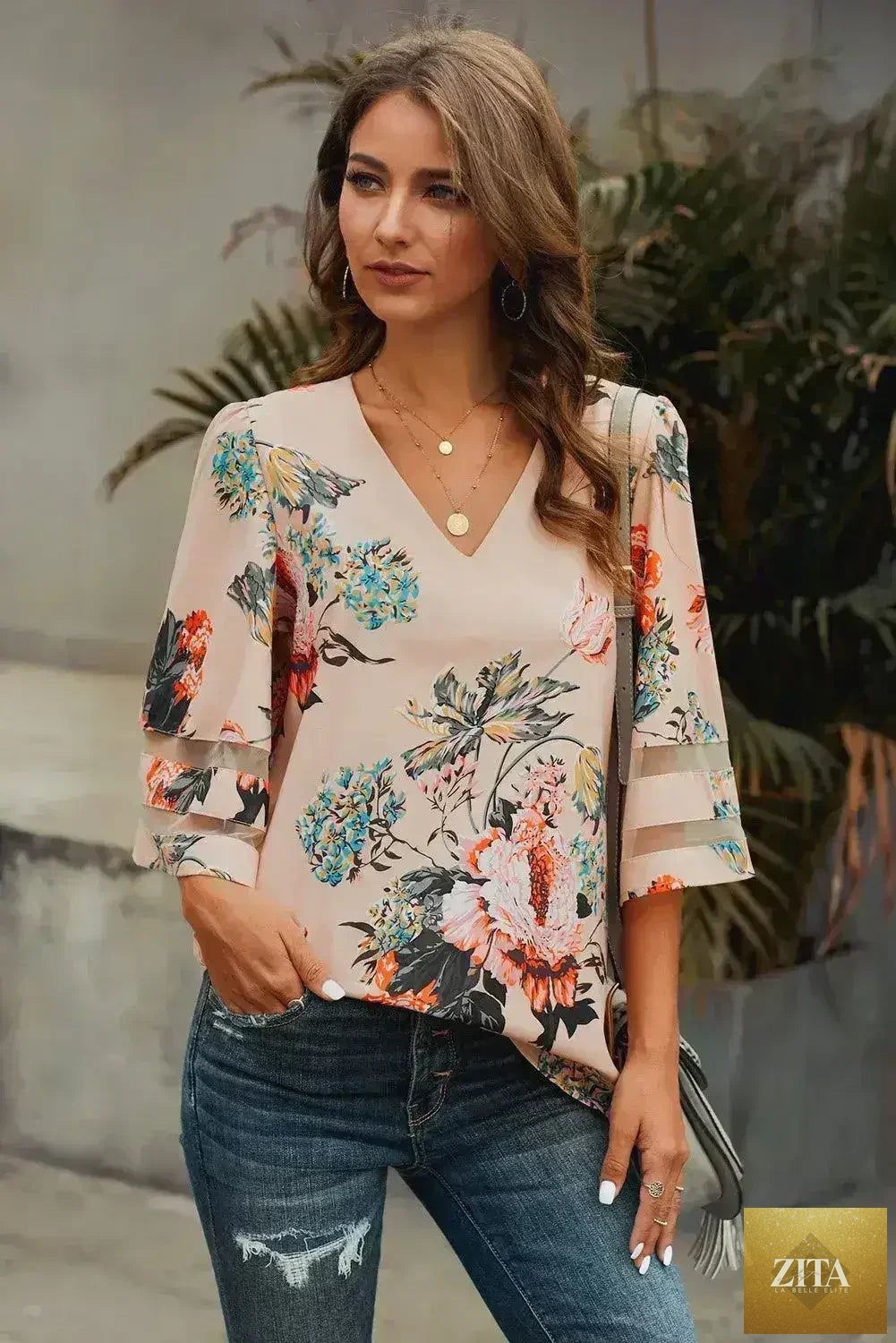Apricot floral chiffon blouse with 3/4 flared sleeves, stylish and breathable, by Femstylo, shown on a hanger.