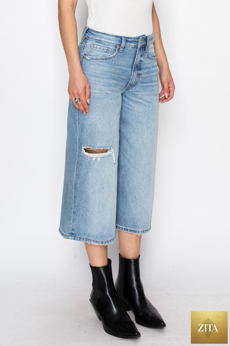 Light blue Artemis Vintage hybrid style ultra high rise relaxed jort jeans with distressed details and rolled cuffs.