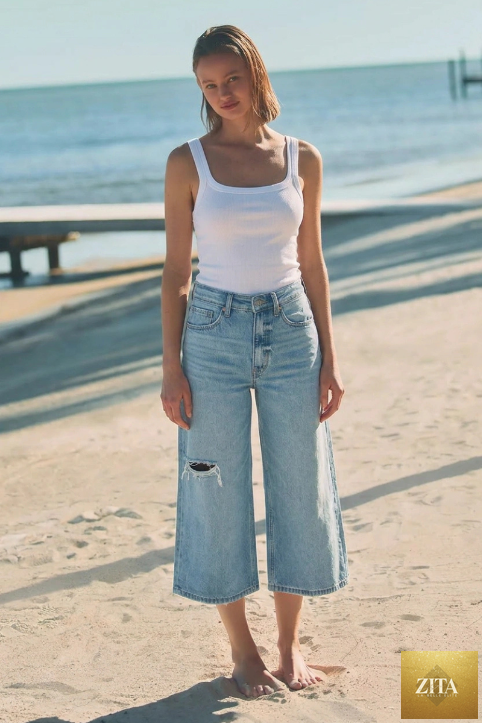 Relaxed fit Ultra High Rise Hybrid Style Jort Jeans by Artemis Vintage, showing the denim with distressed details and relaxed waist.