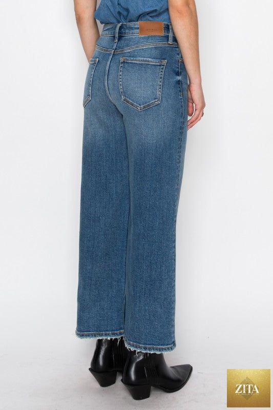 Close-up of Artemis Vintage ultra high rise crop wide jeans showing the light wash denim and wide-leg fit.