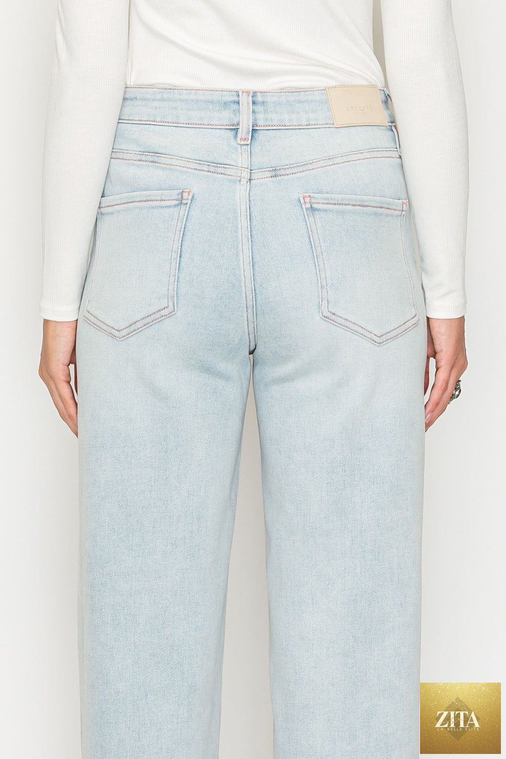Pink high-rise jeans with tummy control and straight-leg fit from Artemis Vintage, featuring modal fabric and pink thread stitching.