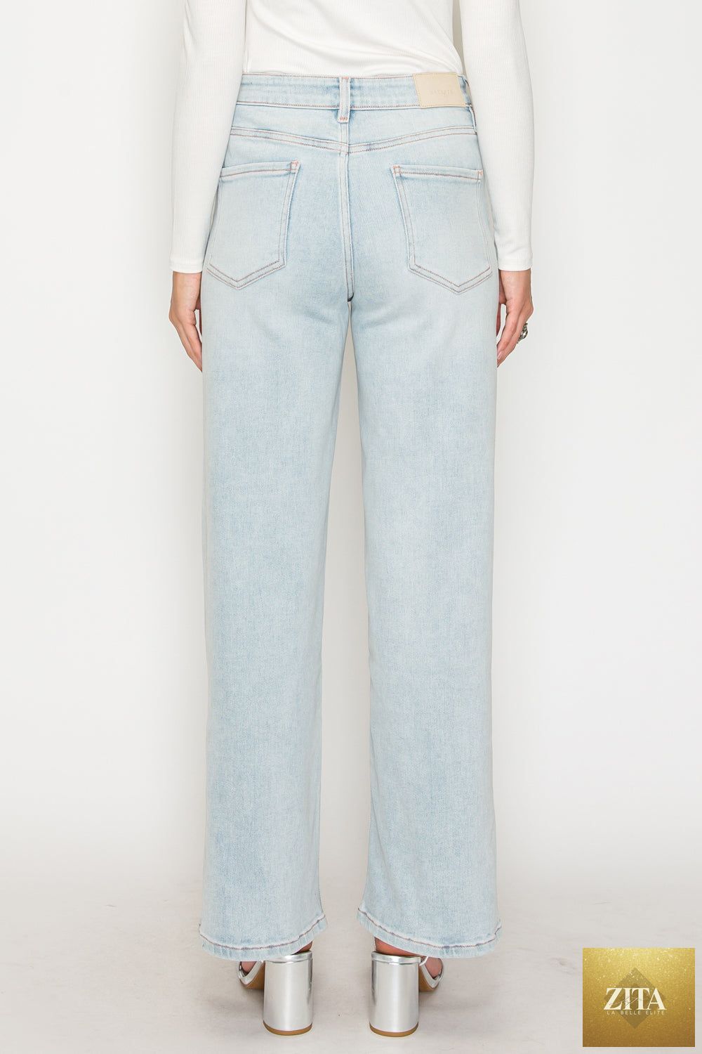 Pink high-rise jeans with tummy control and straight leg cut from Artemis Vintage, showcasing modal fabric and pink thread details.