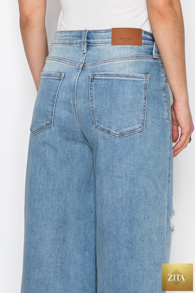 Light blue Artemis Vintage hybrid style ultra high rise relaxed jort jeans with distressed details and rolled cuffs.