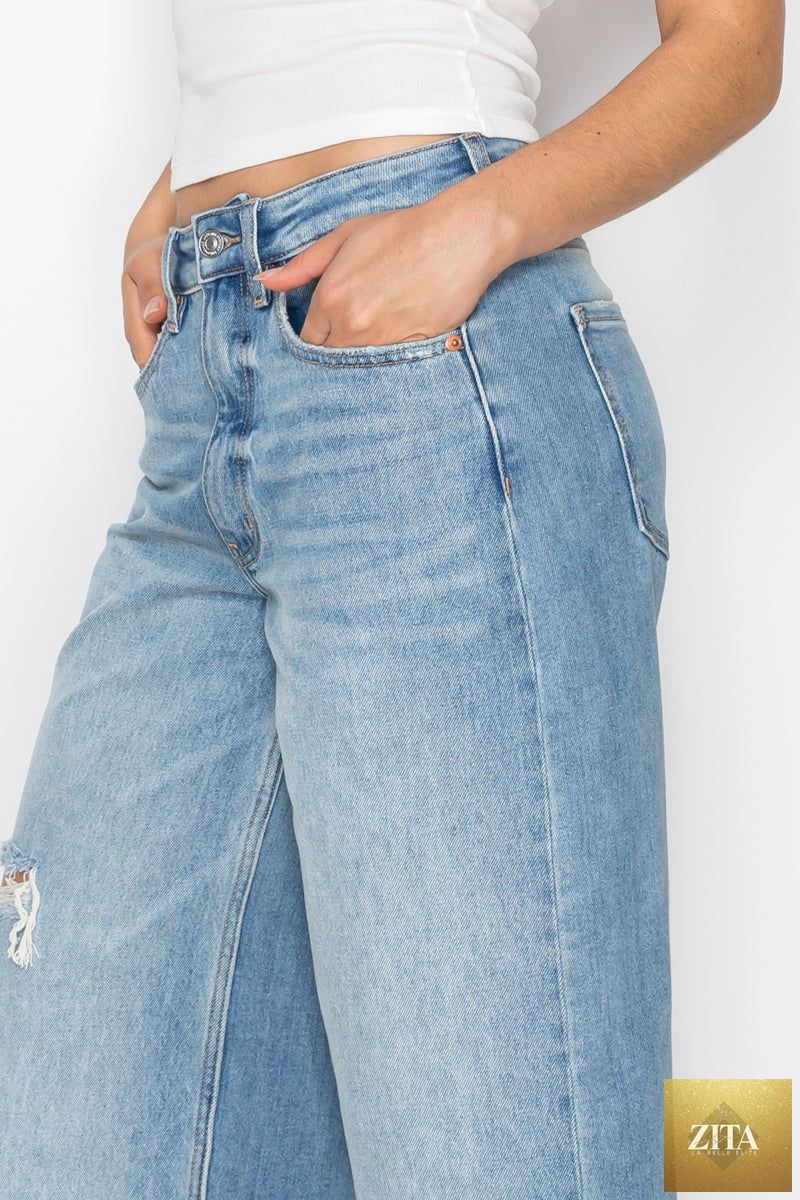 Artemis Vintage hybrid style ultra high rise relaxed jort jeans, showing distressed denim with frayed hems and relaxed fit.