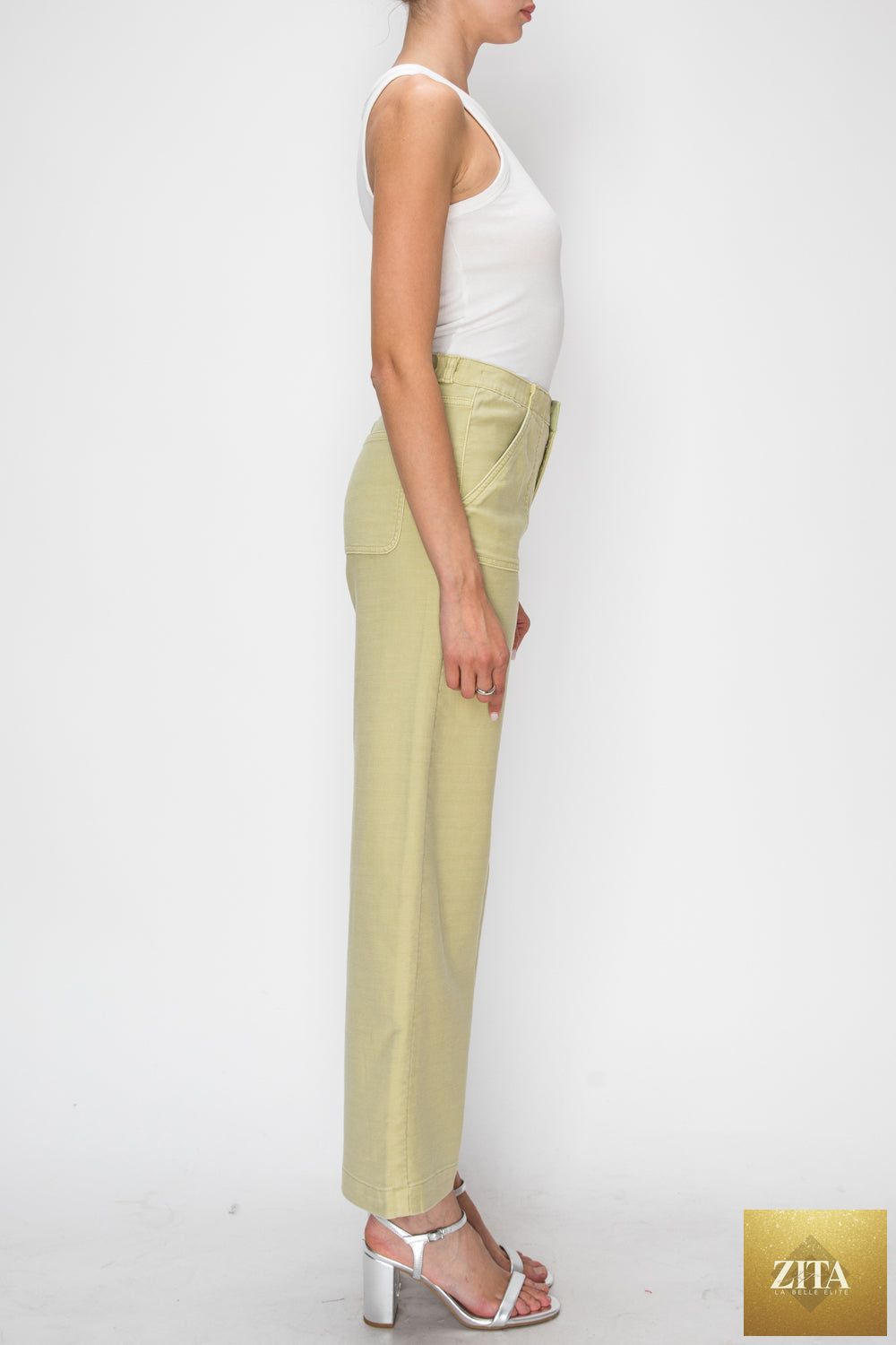 High rise wide-leg sage jeans from Artemis Vintage displayed on a model, showcasing their relaxed fit and stylish high waist.